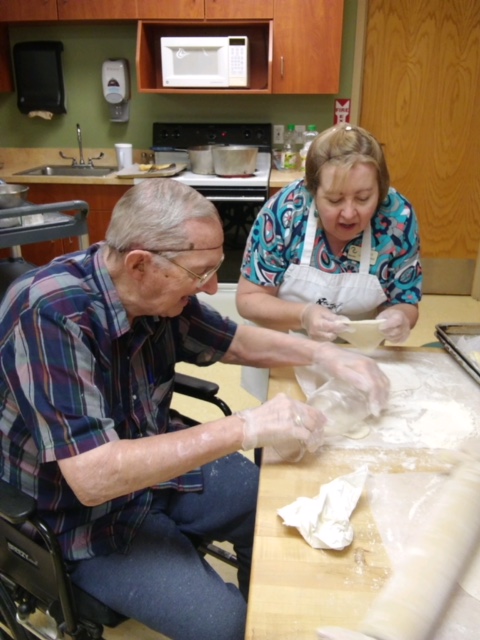 Older man and woman making pastries