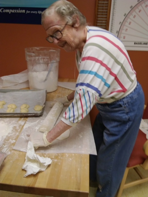 Older man rolling out pastry dough